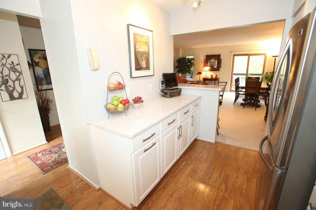 14 Stone Ridge Court, Unit 25 Baltimore, MD 21239 - Photo 6 of 30 a utility room with cabinets washer and dryer