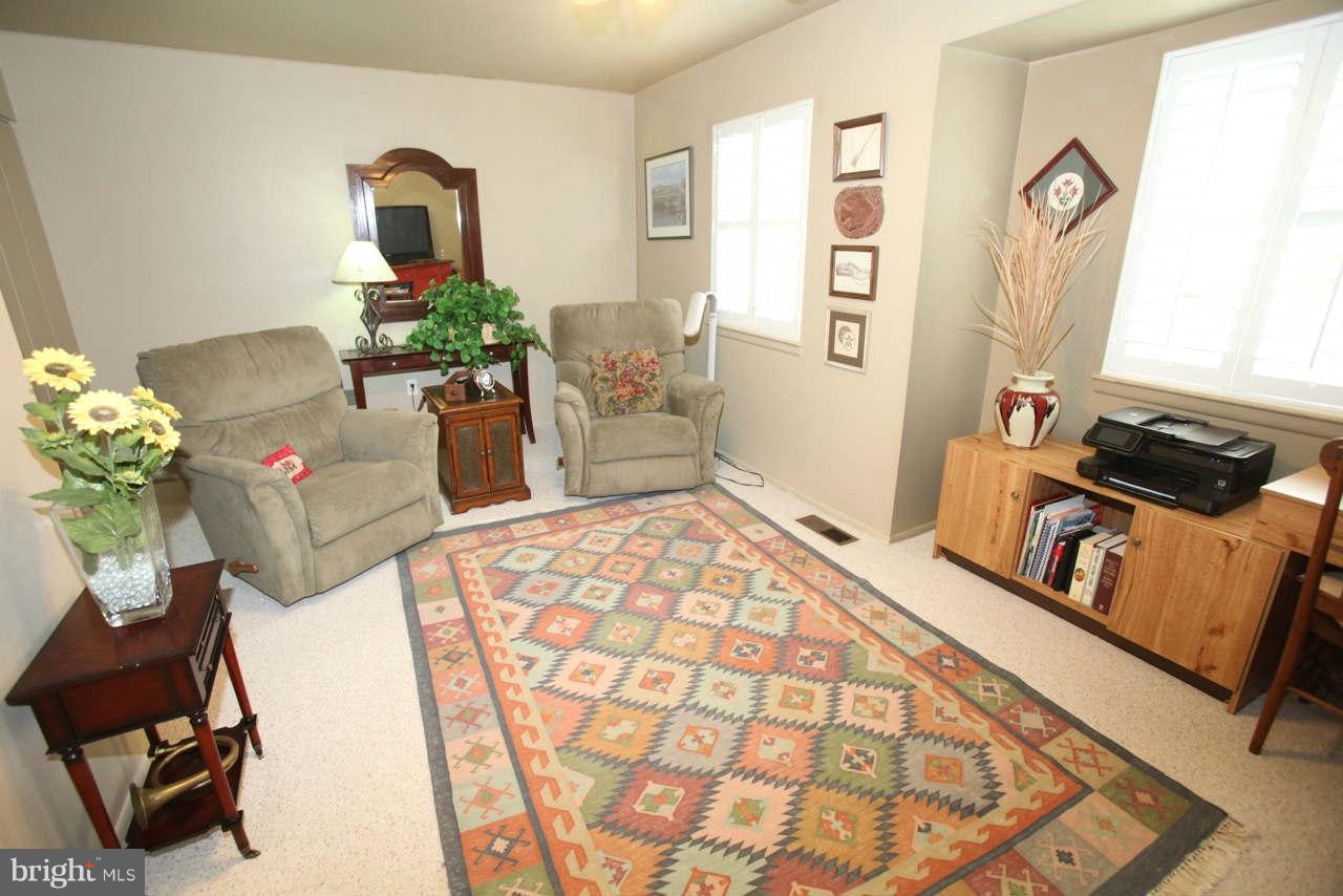 14 Stone Ridge Court, Unit 25 Baltimore, MD 21239 - Photo 9 of 30 a living room with furniture and a window