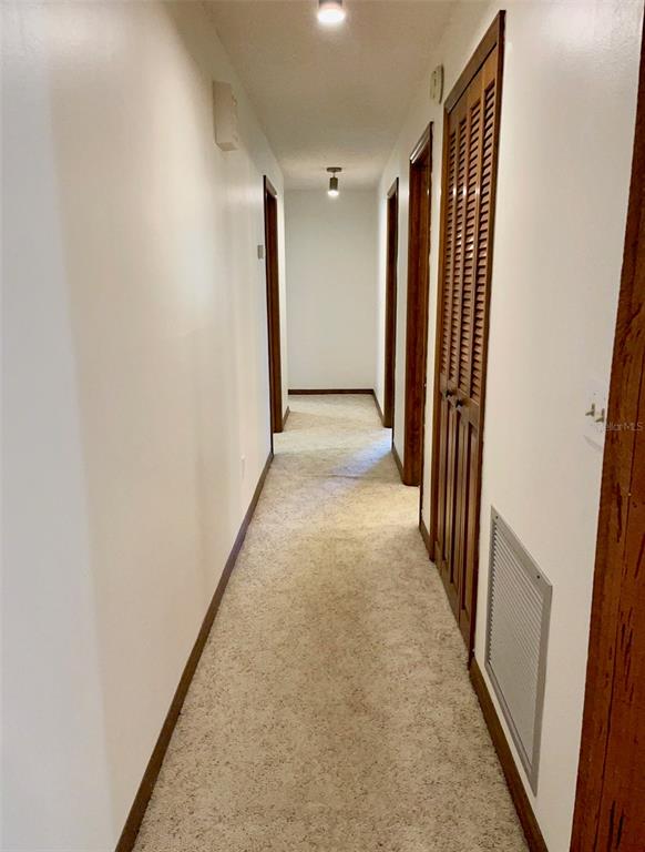 4524 Southeast 11th Place Ocala, FL 34471 - Photo 13 of 31 a view of a hallway with wooden floor