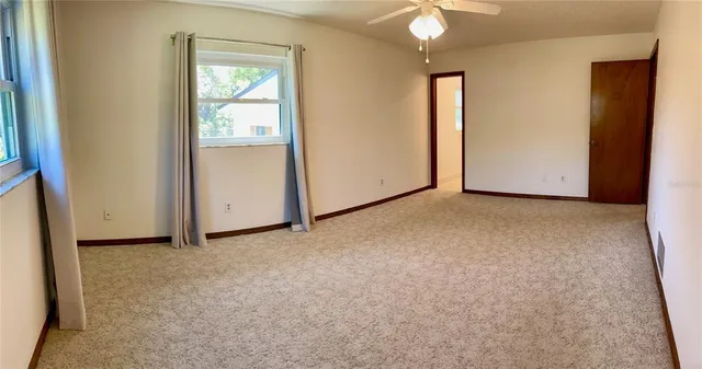 an empty room with windows and closet