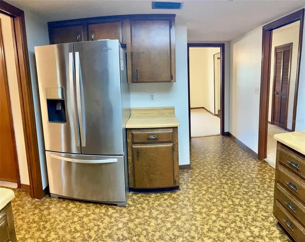 a kitchen with stainless steel appliances granite countertop a refrigerator and a stove
