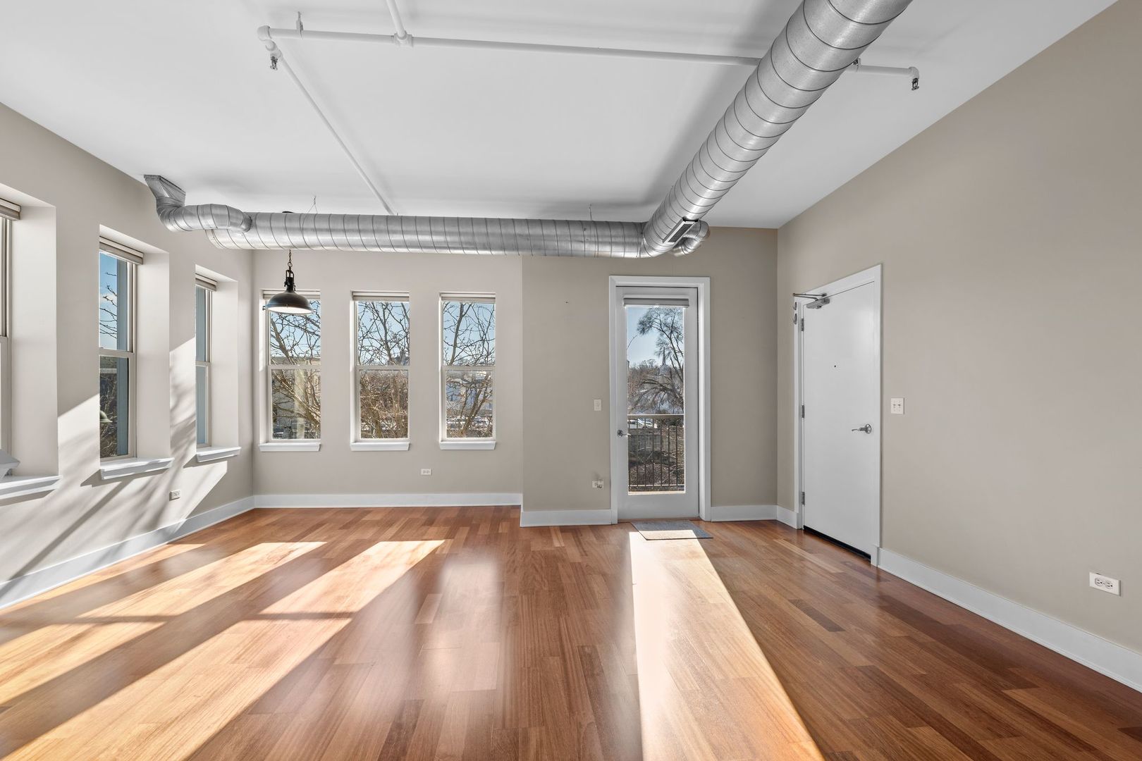 351 Front Street, Unit 2212 Lemont, IL 60439 - Photo 13 of 36 a view of an empty room with wooden floor and a window