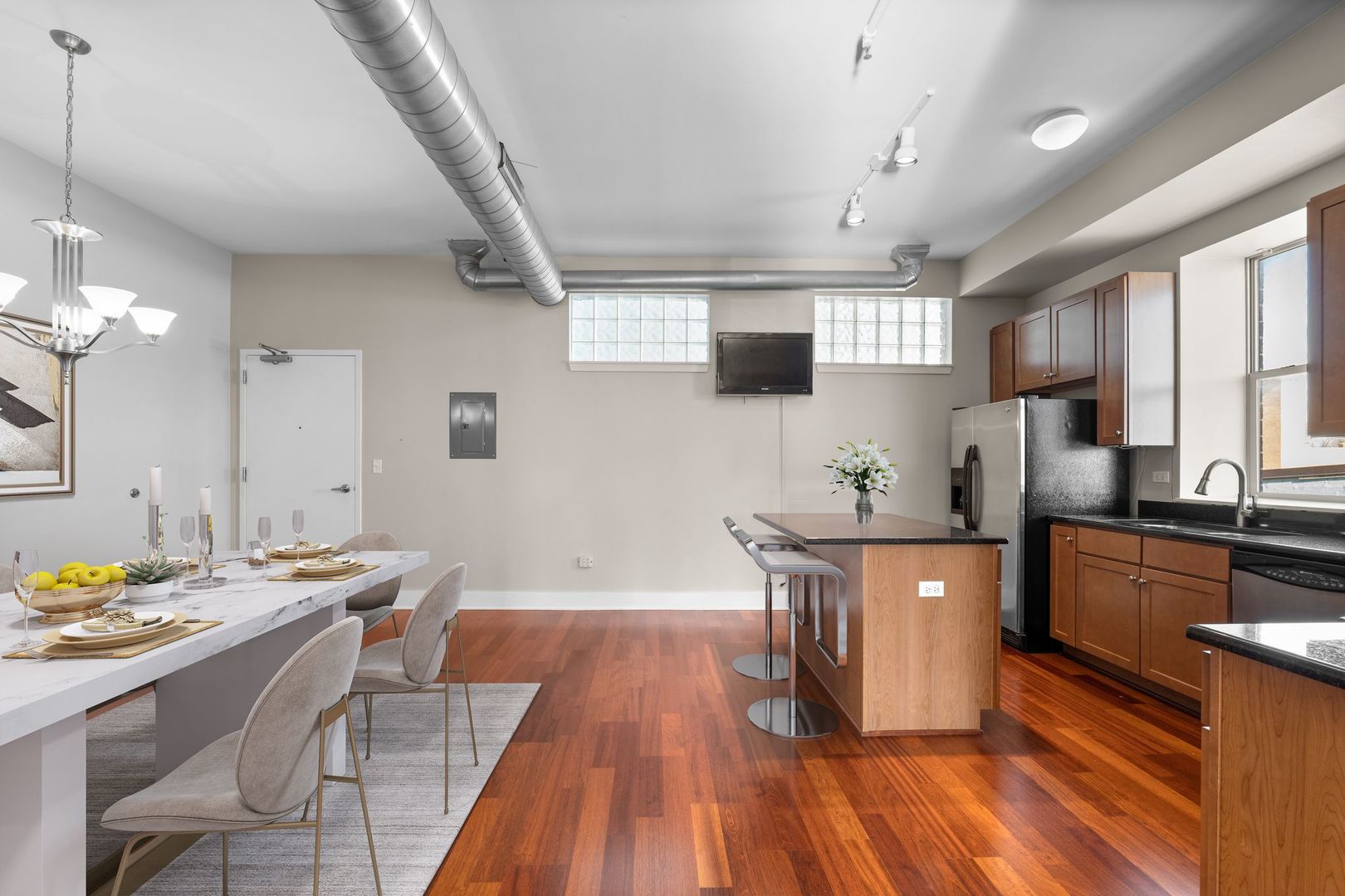 351 Front Street, Unit 2212 Lemont, IL 60439 - Photo 14 of 36 a kitchen with stainless steel appliances a table chairs refrigerator and microwave