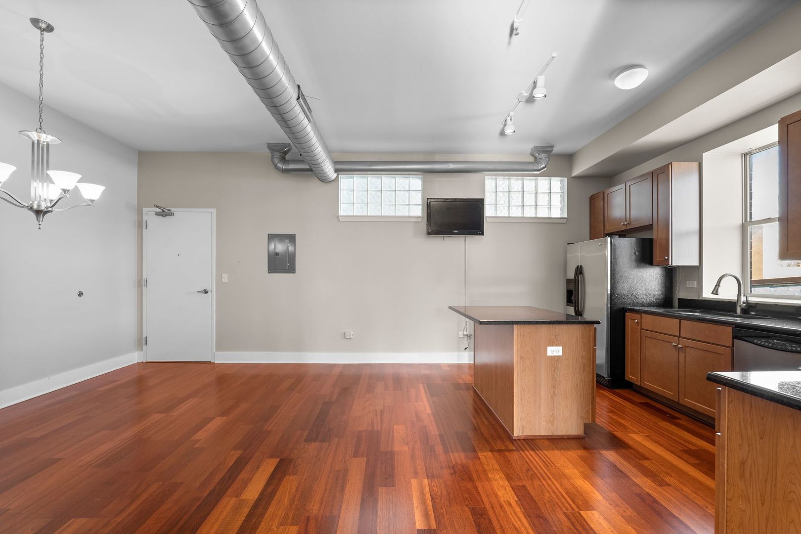 351 Front Street, Unit 2212 Lemont, IL 60439 - Photo 15 of 36 a kitchen with stainless steel appliances wooden floors and view living room