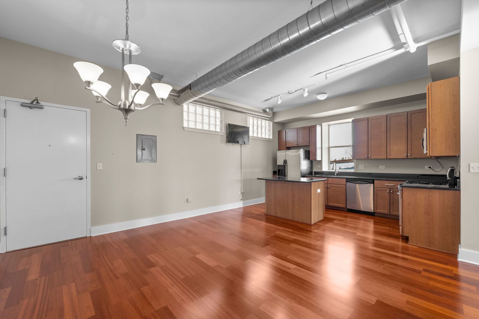 351 Front Street, Unit 2212 Lemont, IL 60439 - Photo 16 of 36 a kitchen with stainless steel appliances granite countertop wooden floors and white cabinets