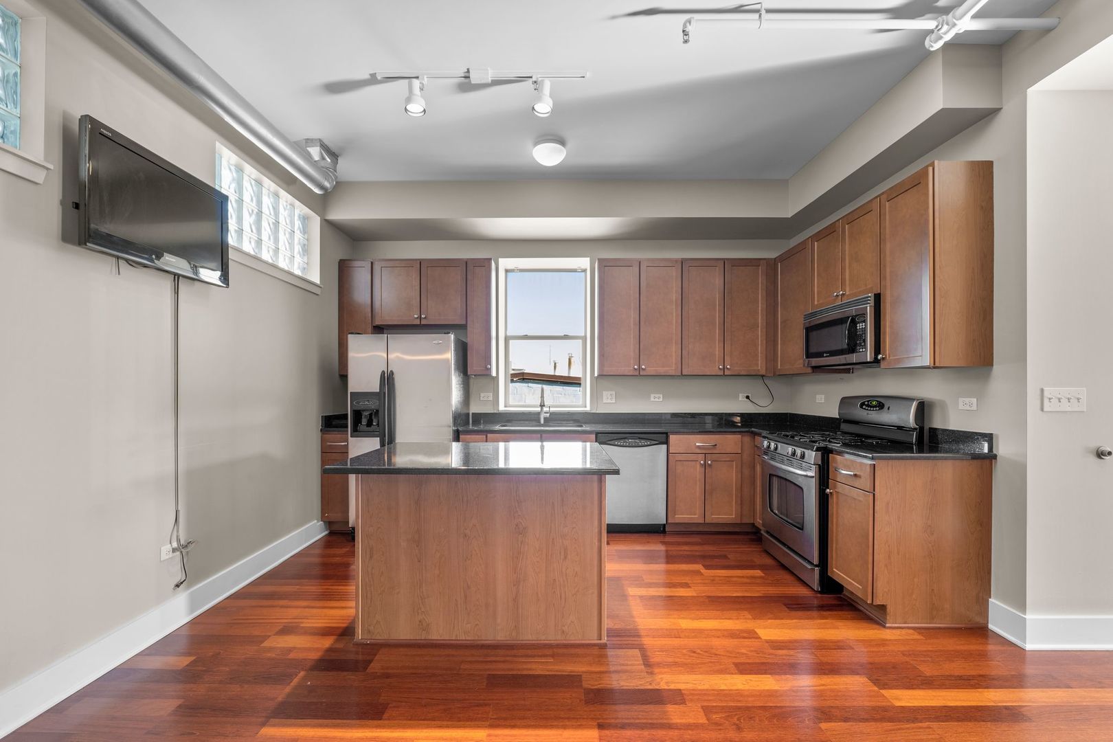 351 Front Street, Unit 2212 Lemont, IL 60439 - Photo 17 of 36 a kitchen with stainless steel appliances granite countertop a refrigerator a stove top oven a sink and dishwasher with wooden floor