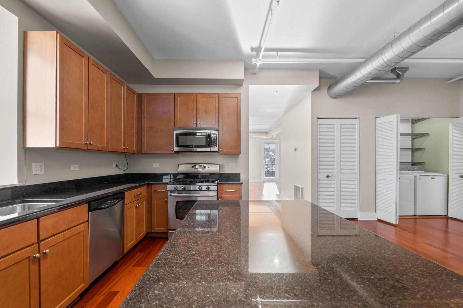 351 Front Street, Unit 2212 Lemont, IL 60439 - Photo 18 of 36 a kitchen with stainless steel appliances granite countertop a refrigerator and a stove top oven