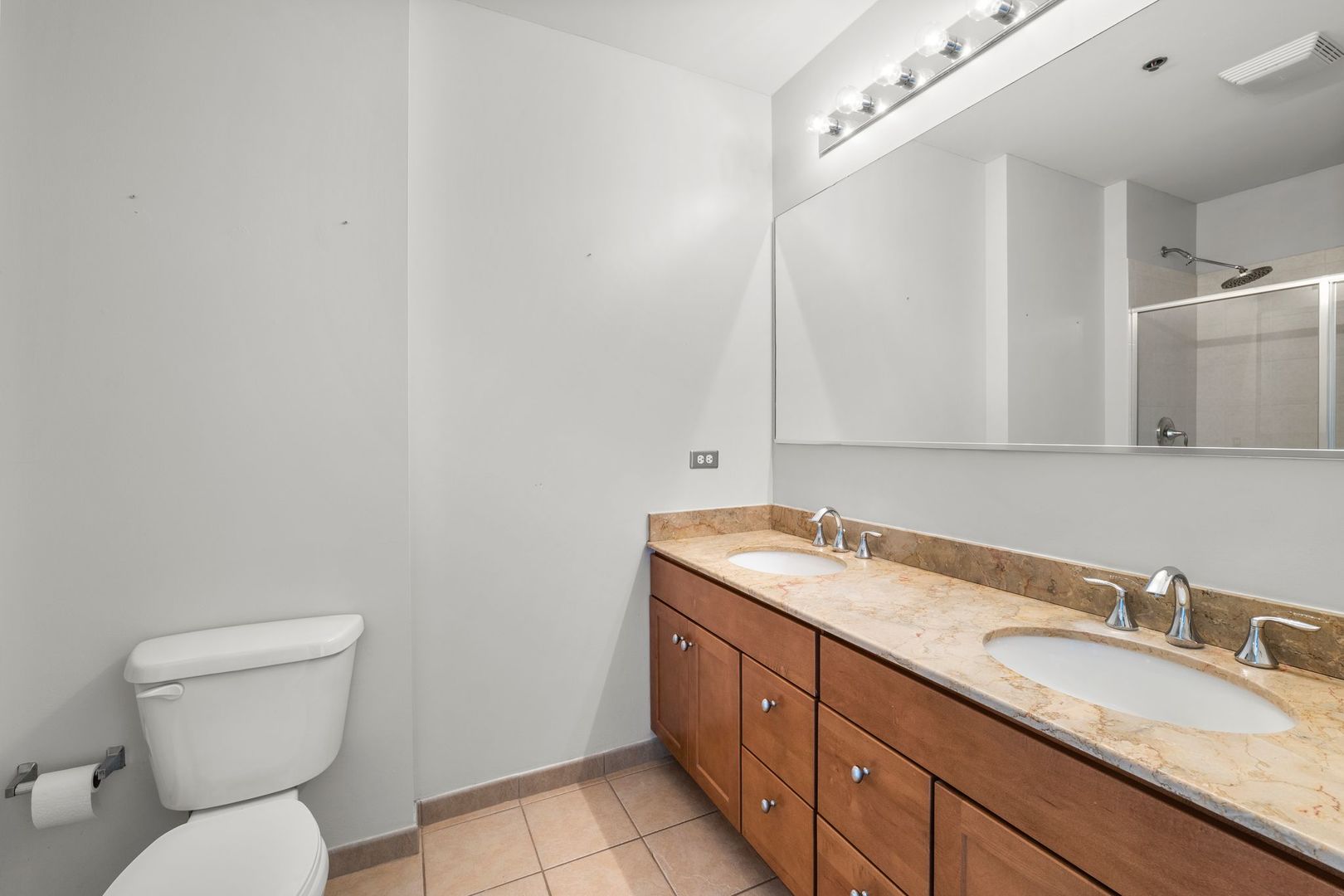 351 Front Street, Unit 2212 Lemont, IL 60439 - Photo 29 of 36 a bathroom with a granite countertop sink toilet and mirror
