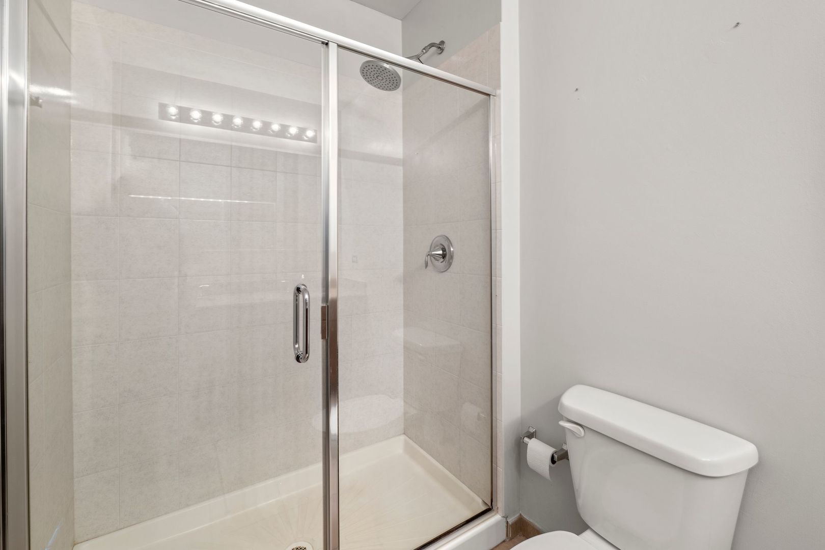 351 Front Street, Unit 2212 Lemont, IL 60439 - Photo 30 of 36 a bathroom with a shower a toilet and a sink