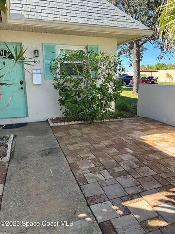 a view of a backyard with plants and outdoor seating