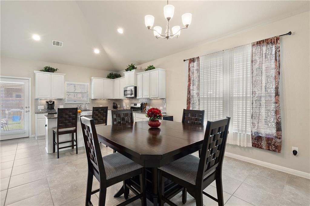 601 Flag Lane Leander, TX 78641 - Photo 11 of 38 a view of a dining room with furniture and chandelier