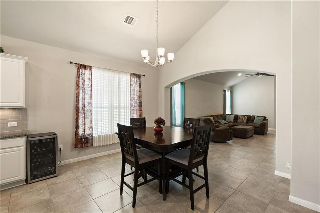 601 Flag Lane Leander, TX 78641 - Photo 15 of 38 a view of a dining room with furniture and a chandelier