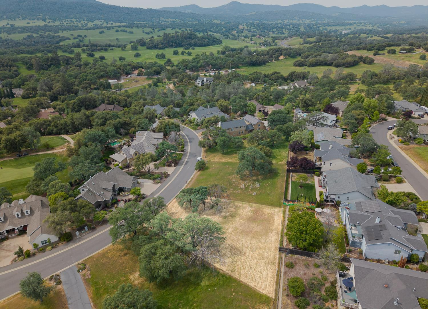 264 Blair Mine Road Angels Camp, CA 95222 - Photo 2 of 26 an aerial view of green landscape with trees houses and mountain view