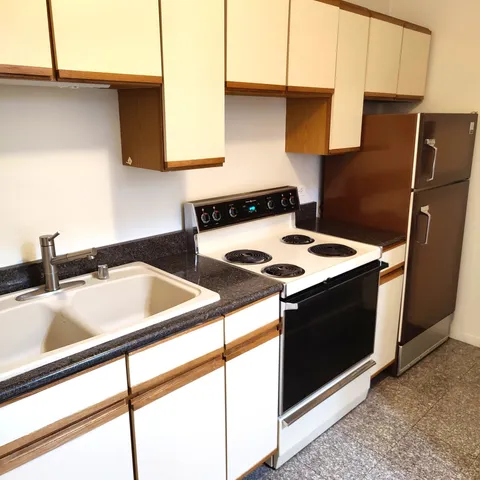 a kitchen with a sink and a refrigerator