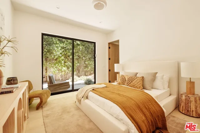 a bedroom with a bed and glass window