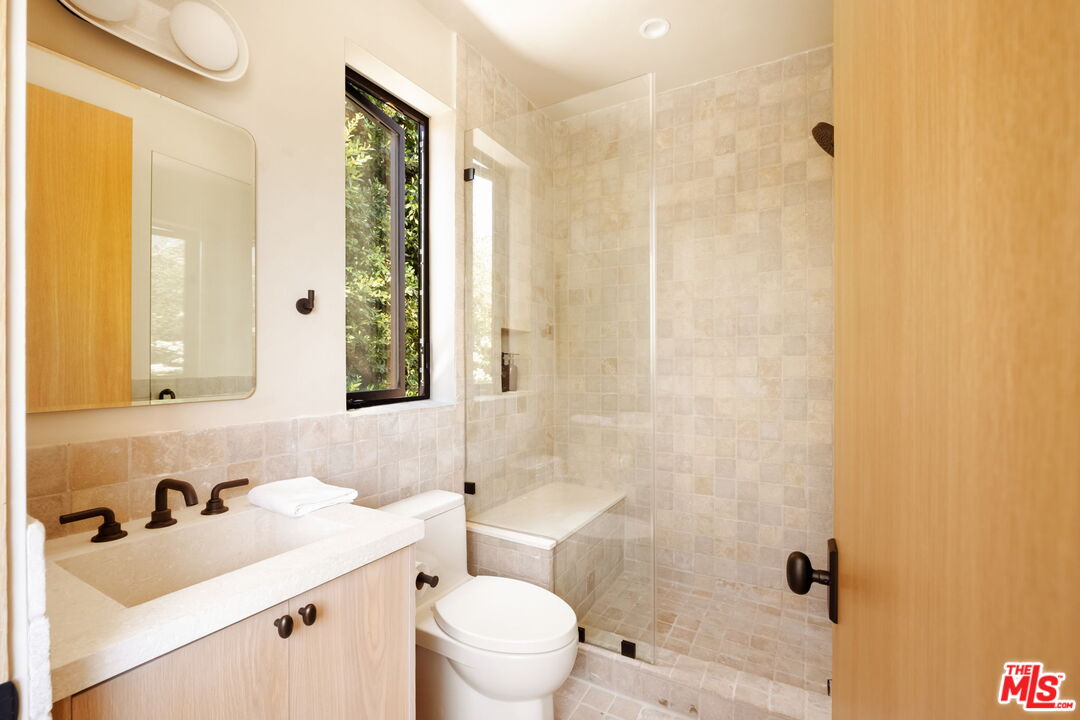 636 North Laurel Avenue Los Angeles, CA 90048 - Photo 26 of 31 a bathroom with a sink toilet and shower