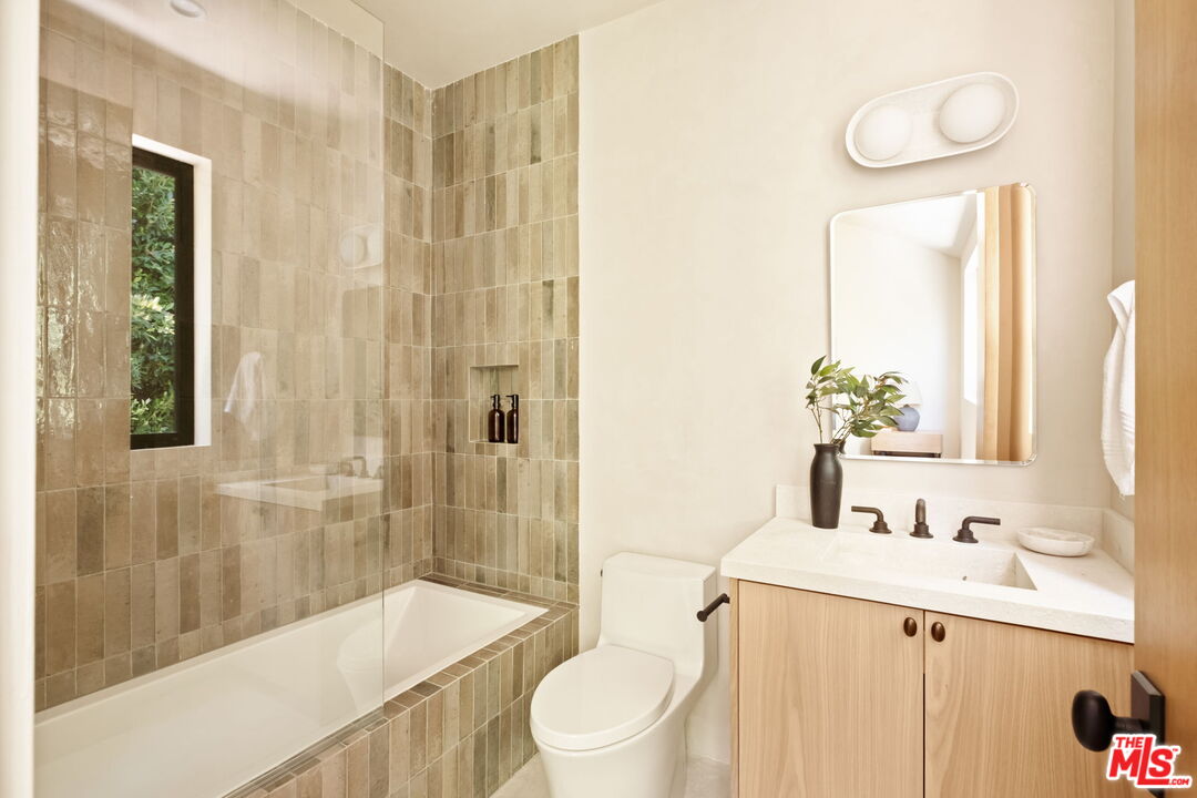 636 North Laurel Avenue Los Angeles, CA 90048 - Photo 28 of 31 a bathroom with a sink a toilet and shower