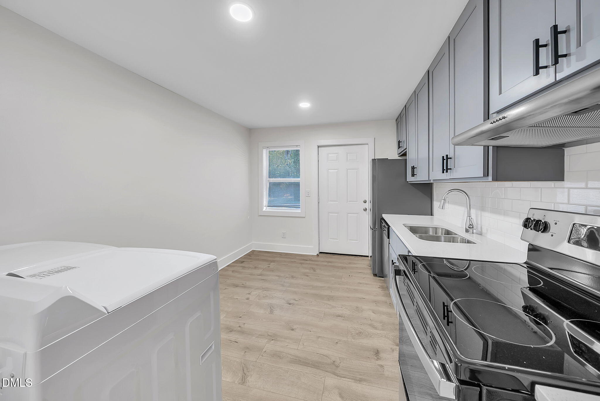 510 East Branch Street Spring Hope, NC 27882 - Photo 11 of 32 a kitchen with kitchen island a stove a sink and a refrigerator