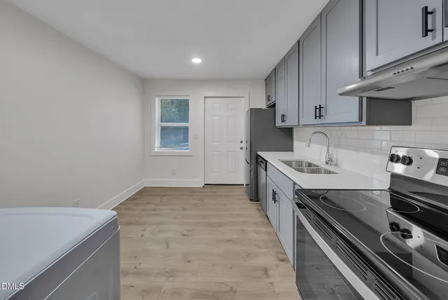 a kitchen with a stove and a sink