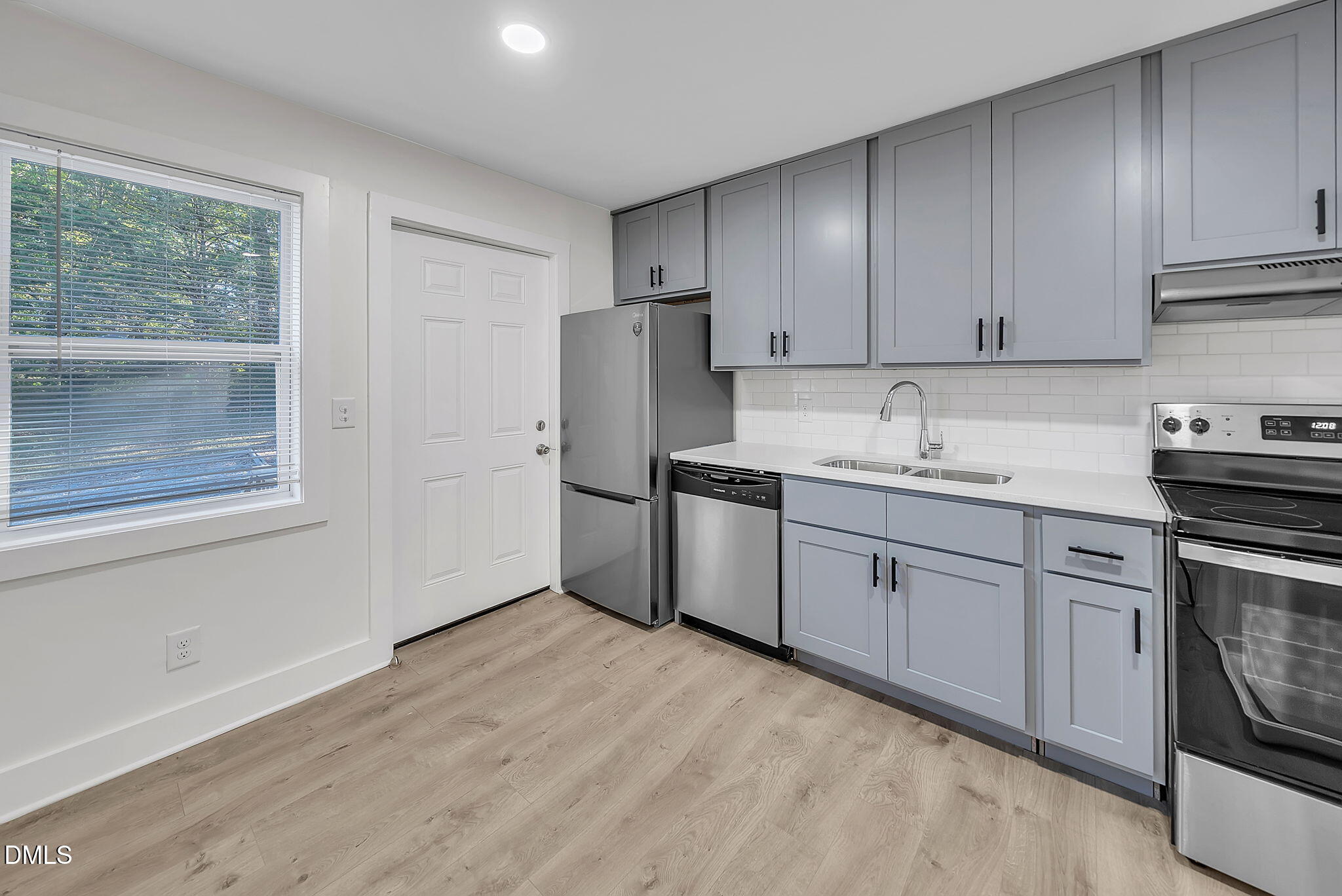 510 East Branch Street Spring Hope, NC 27882 - Photo 15 of 32 a kitchen with a sink cabinets stainless steel appliances and a window