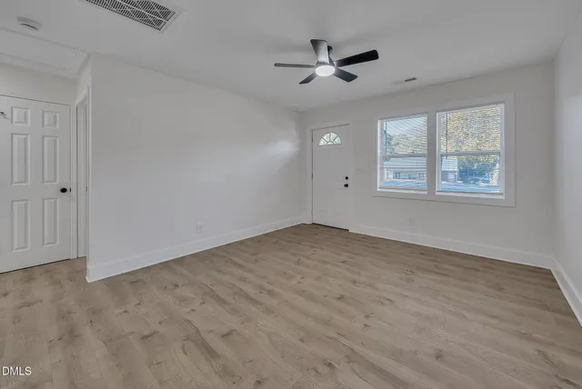 wooden floor in an empty room with a window