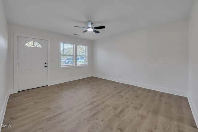 wooden floor in an empty room with a window