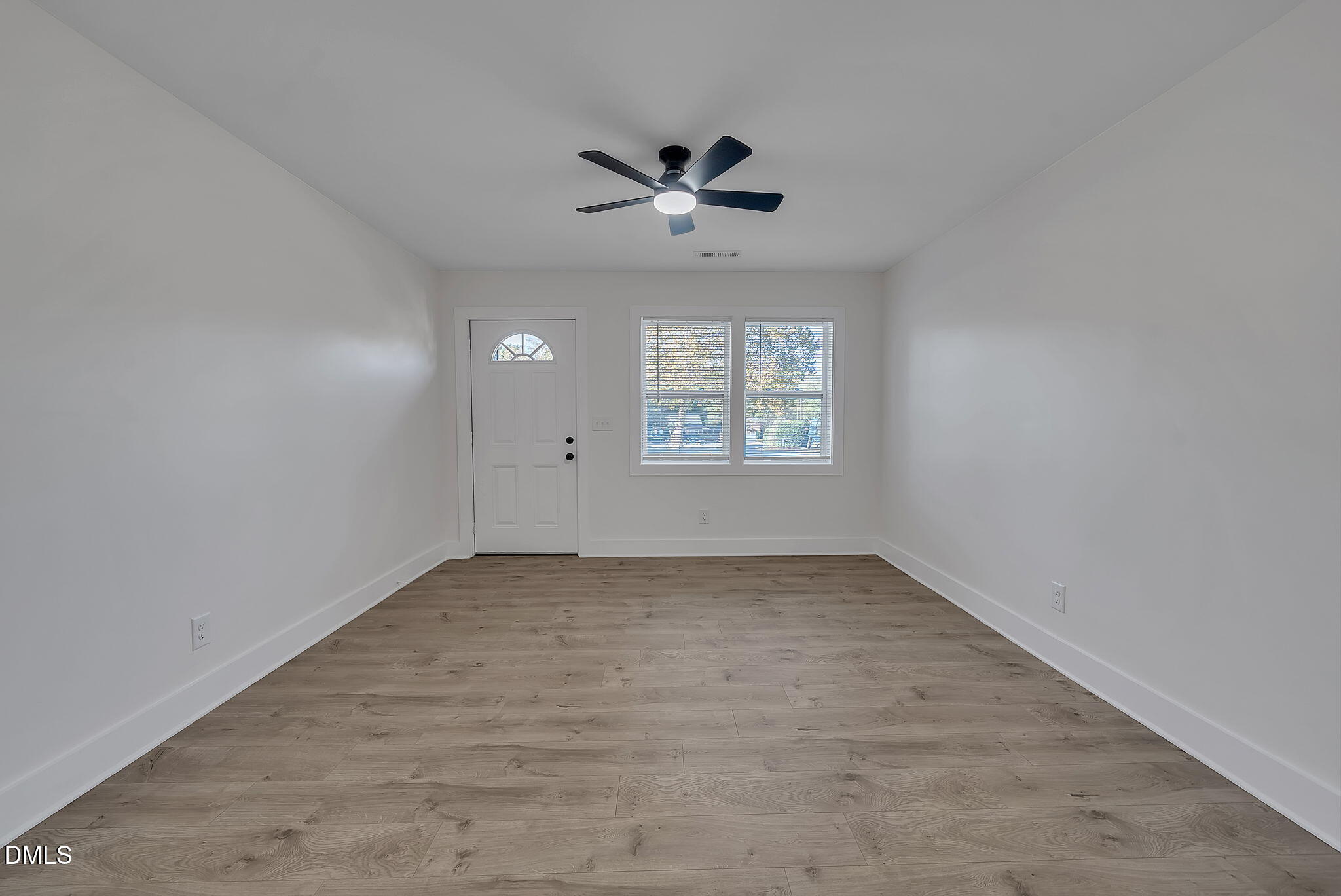 510 East Branch Street Spring Hope, NC 27882 - Photo 9 of 32 an empty room with windows and ceiling fan