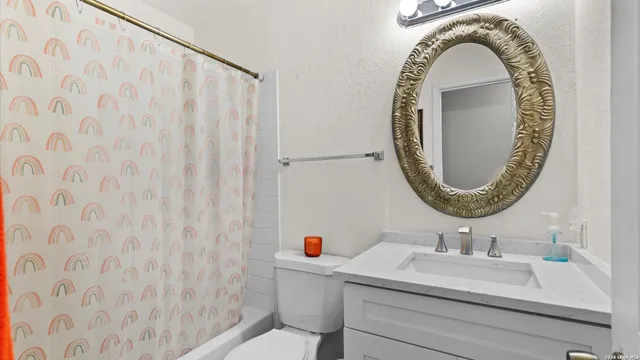 a bathroom with a sink a mirror and a shower