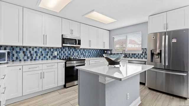 a kitchen with a sink stove and refrigerator