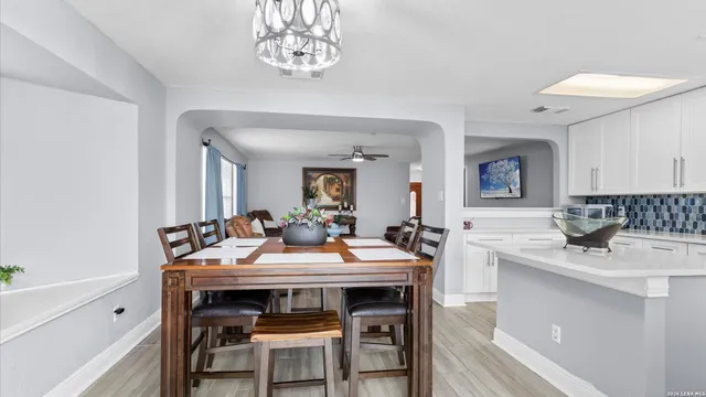 a view of a dining room with furniture and a chandelier