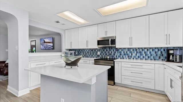 a kitchen with a sink stove and cabinets