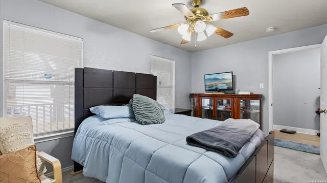 a bedroom with a large bed and a chandelier
