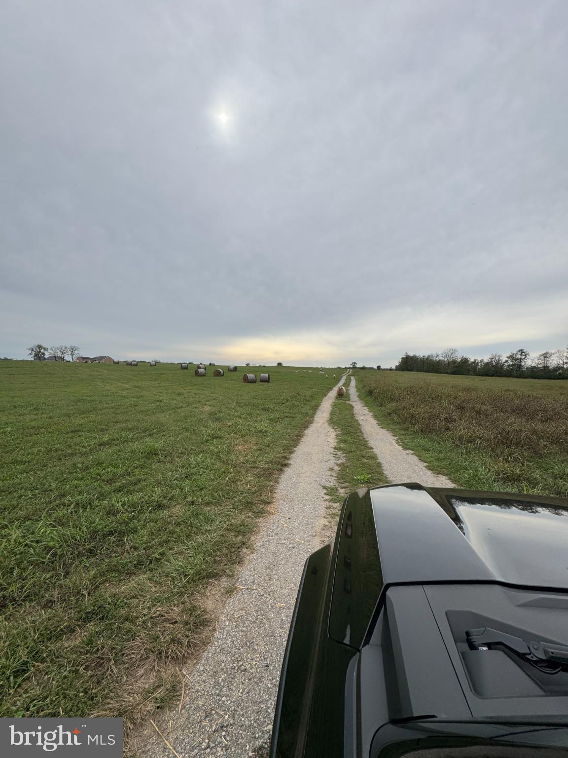 1196 Van Clevesville Road Kearneysville, WV 25430 - Photo 2 of 3 Serene country road under a cloudy sky.