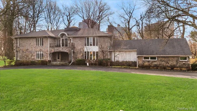 a view of a house with a yard and sitting area