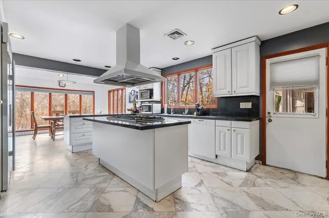 a kitchen with stainless steel appliances granite countertop a sink and cabinets