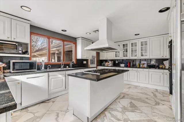 a kitchen with stainless steel appliances granite countertop a stove and a sink