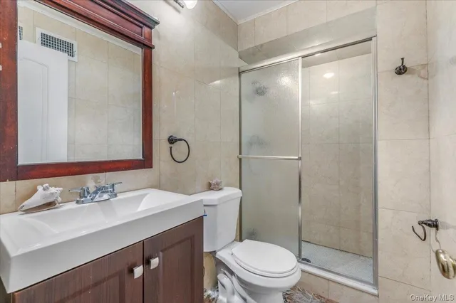 a bathroom with a sink mirror toilet and shower