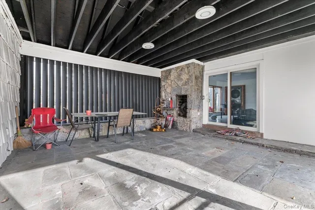 a view of a chairs and table in patio