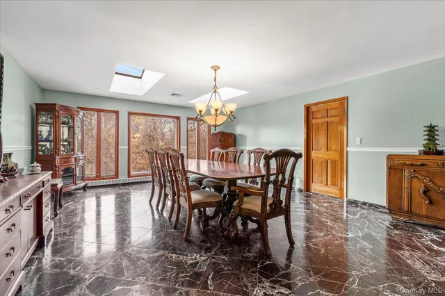 a view of a dining room with furniture window and outside view