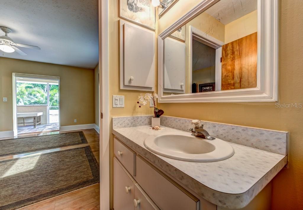 1453 Nantucket Road Venice, FL 34293 - Photo 20 of 35 The en suite master bath has a walk-in shower with bench/shelf and a window to let in natural light.