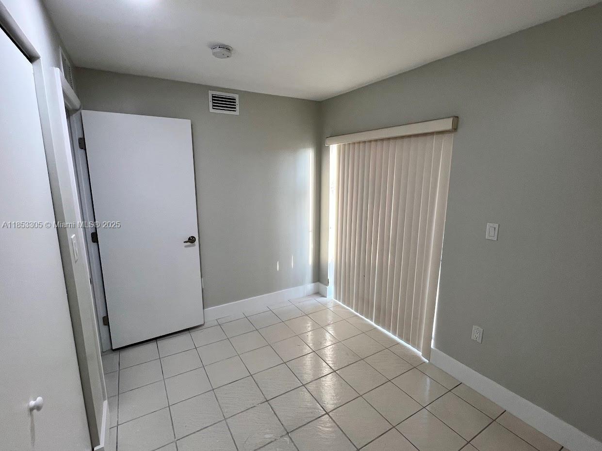 1331 Southwest 124th Court, Unit E3 Miami, FL 33184 - Photo 11 of 17 a view of a hallway to rooms