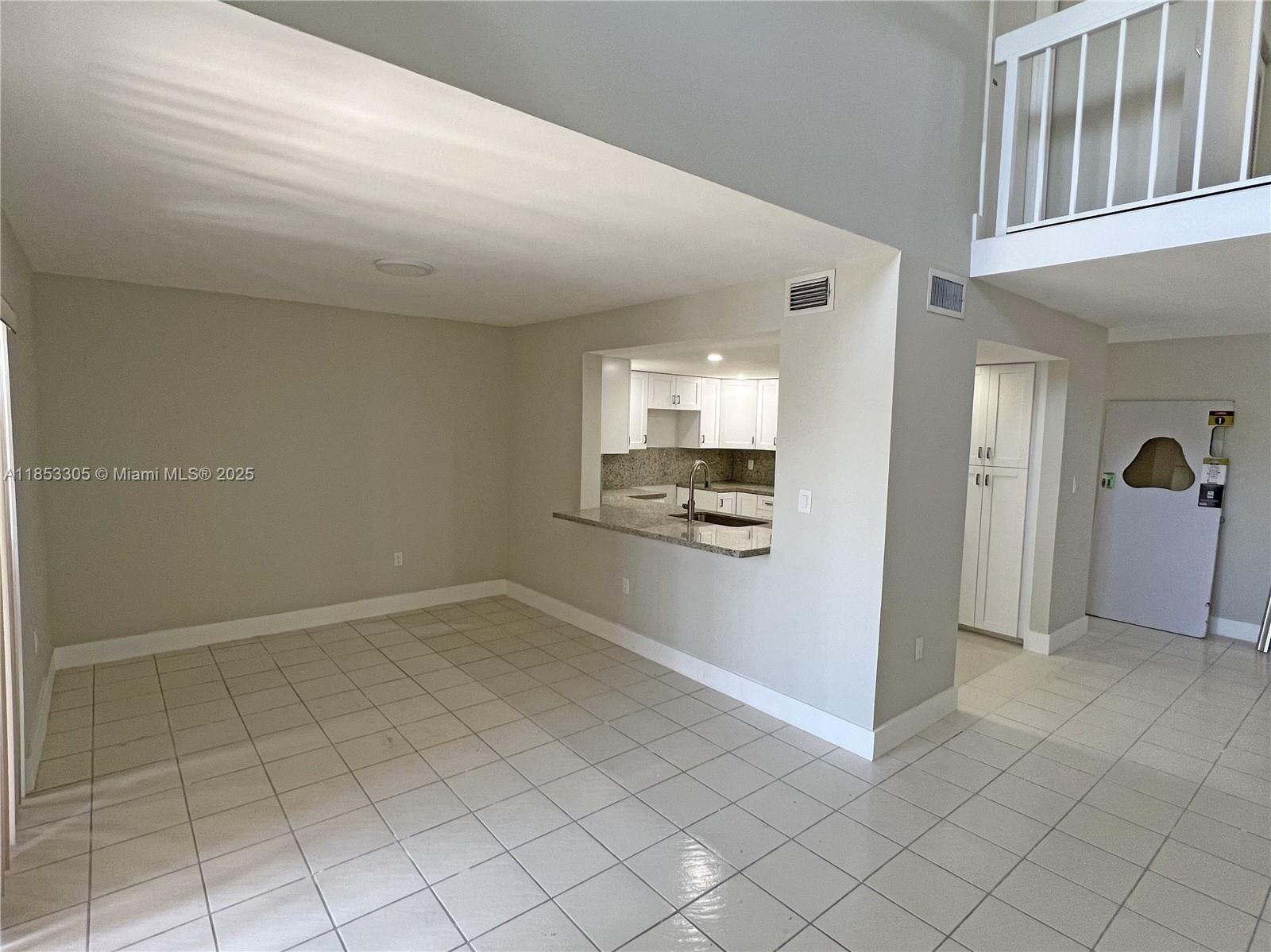 1331 Southwest 124th Court, Unit E3 Miami, FL 33184 - Photo 2 of 17 a view of an empty room and window