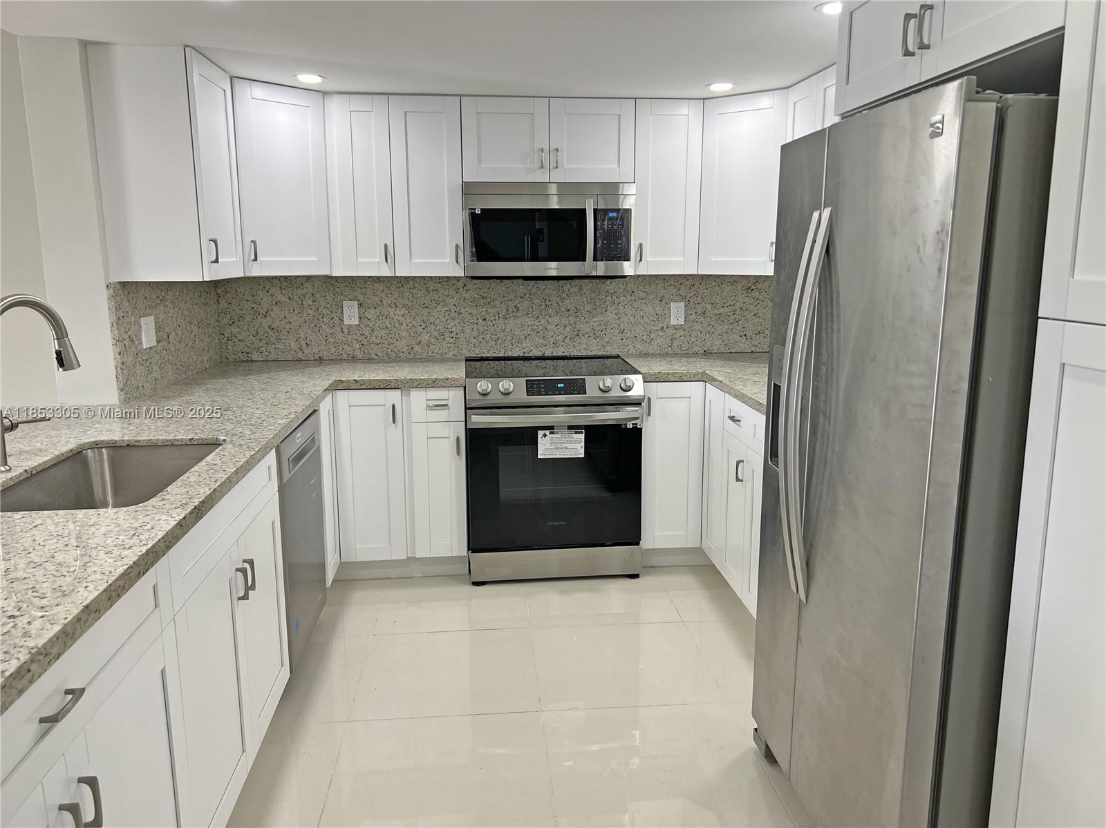 1331 Southwest 124th Court, Unit E3 Miami, FL 33184 - Photo 3 of 17 a kitchen with a stove sink and refrigerator
