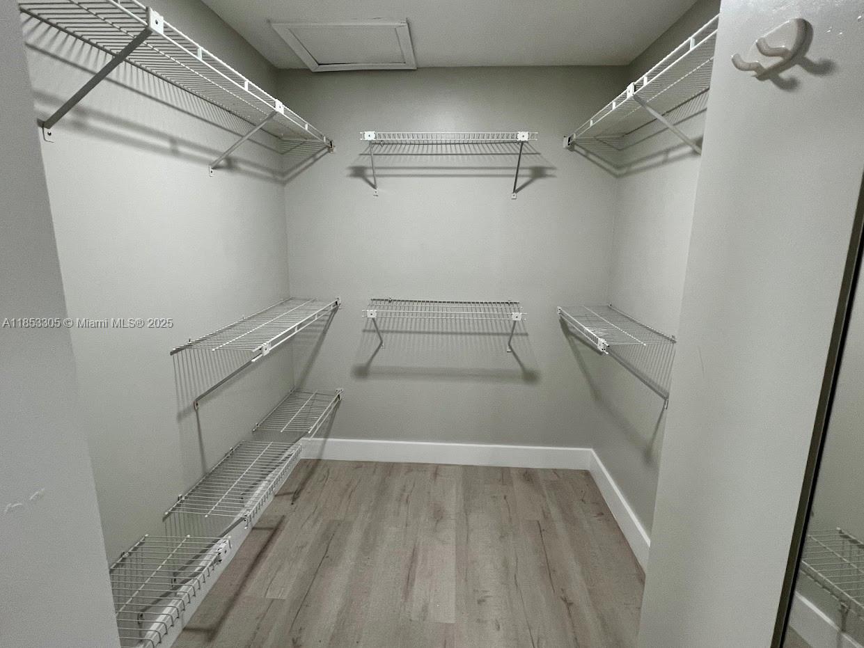 1331 Southwest 124th Court, Unit E3 Miami, FL 33184 - Photo 6 of 17 a view of a room with racks on the wall