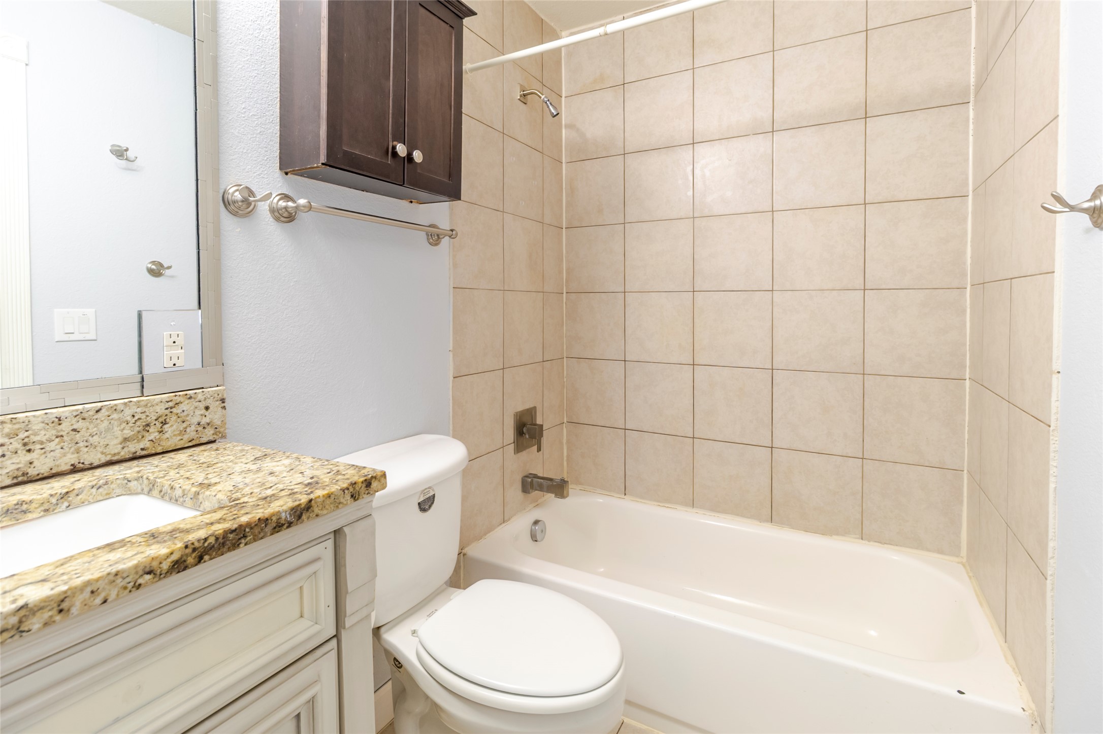 4459 Pettytown Road Dale, TX 78616 - Photo 17 of 30 a bathroom with a granite countertop bathtub shower sink vanity and toilet