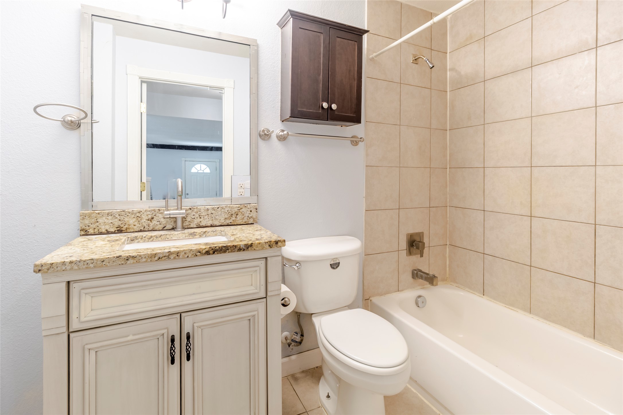 4459 Pettytown Road Dale, TX 78616 - Photo 18 of 30 a bathroom with a granite countertop sink a toilet and mirror
