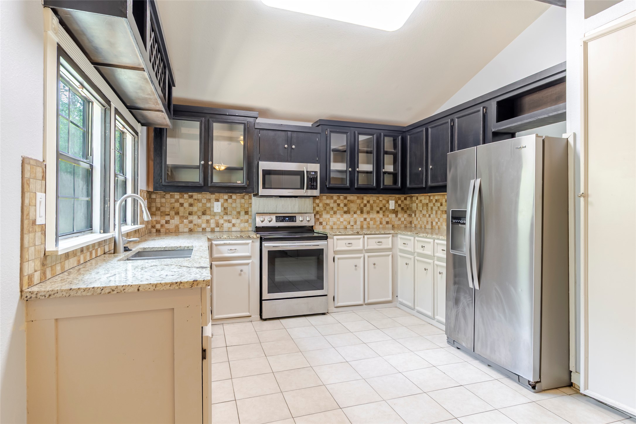 4459 Pettytown Road Dale, TX 78616 - Photo 22 of 30 a kitchen with stainless steel appliances granite countertop a refrigerator sink and stove