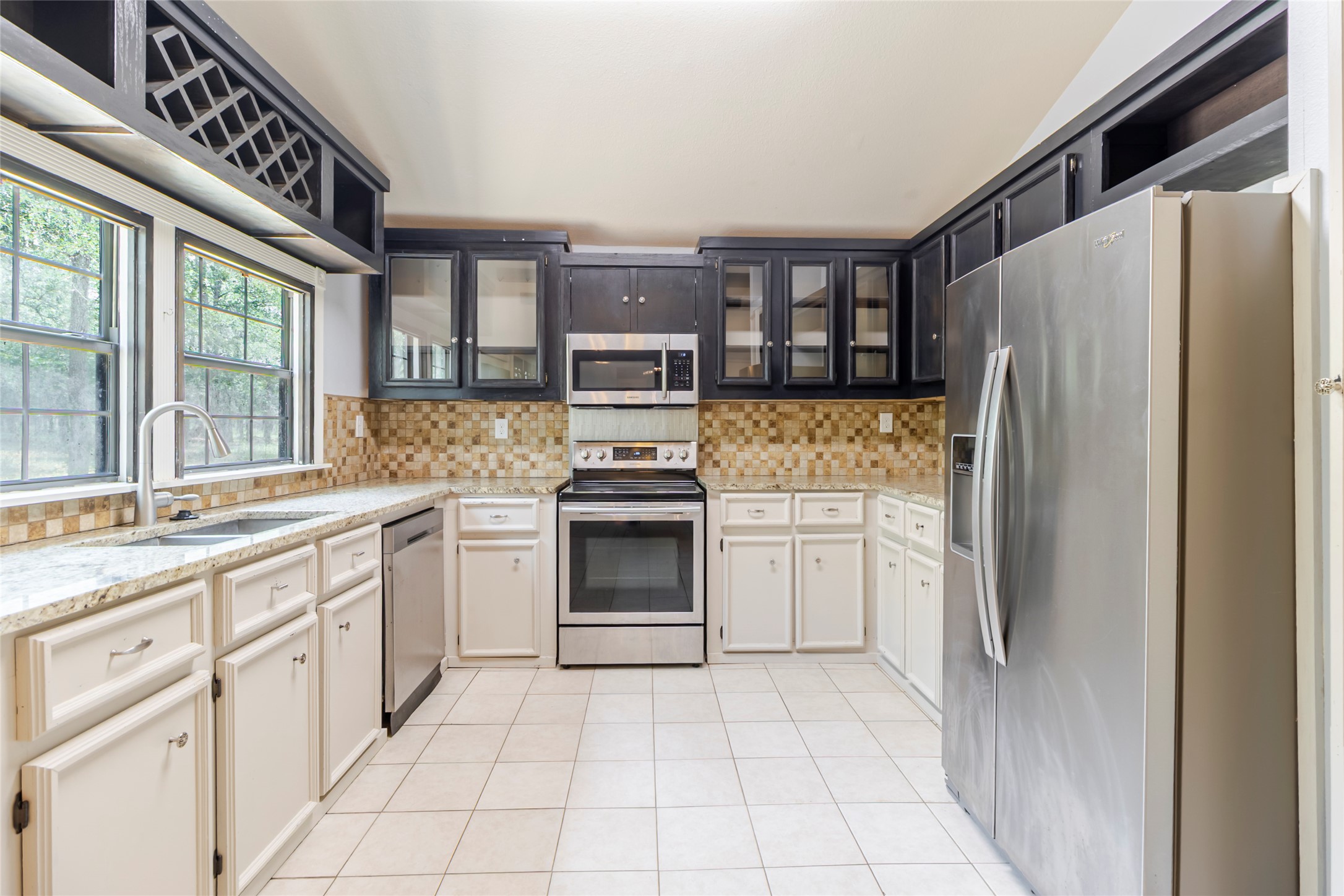 4459 Pettytown Road Dale, TX 78616 - Photo 25 of 30 a kitchen with granite countertop a refrigerator and a stove top oven