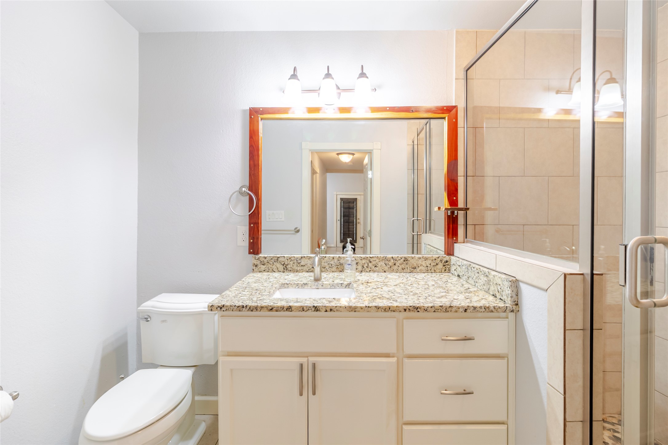 4459 Pettytown Road Dale, TX 78616 - Photo 30 of 30 a bathroom with a granite countertop sink vanity mirror and toilet