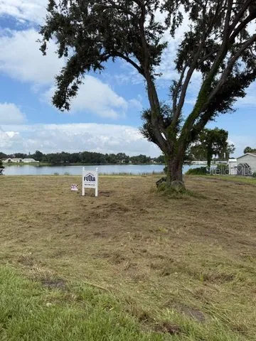 a view of a lake with houses in the back